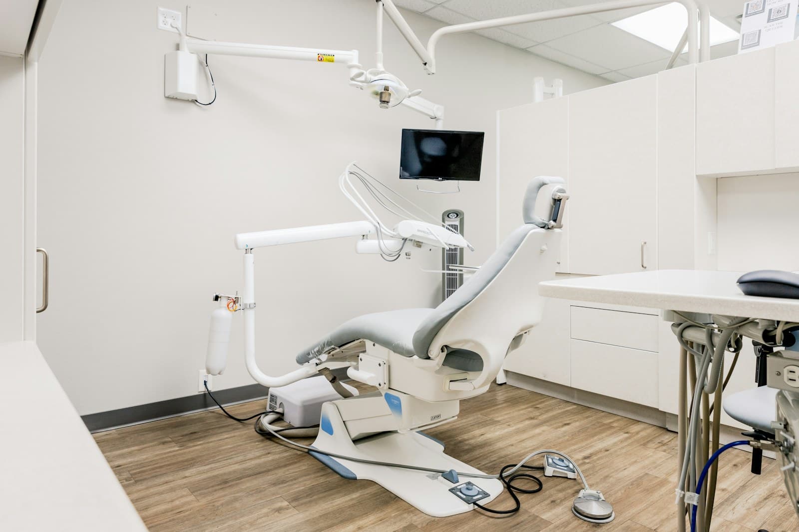 A calm treatment room at Saltwater Dental with the chair set against warm timber floors and daylight
