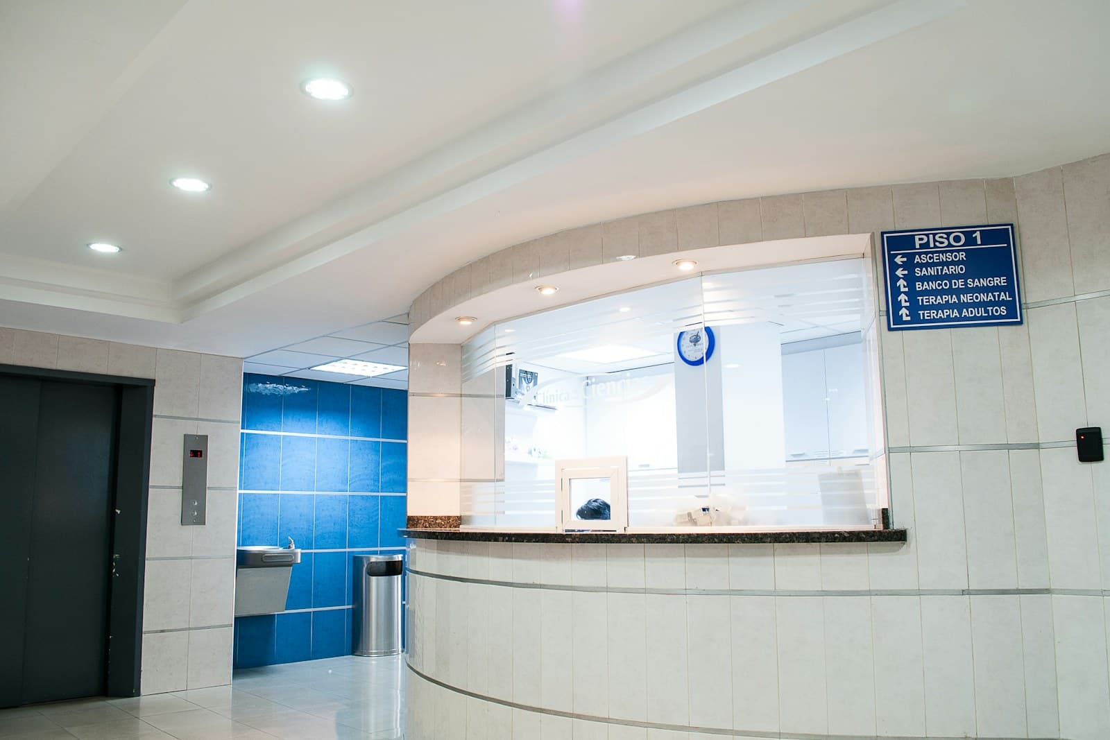 The Saltwater Dental front desk, with a curved reception counter and a team member ready to greet patients