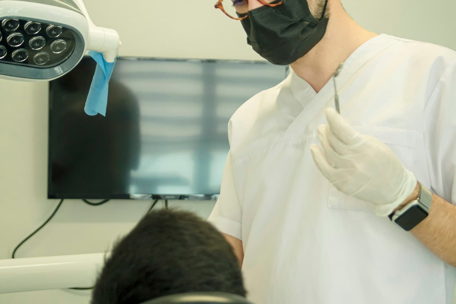 A clinician talking a seated patient through their treatment options